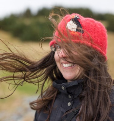 Photo of Catherine outside wearing a tuque and her hair blow by the wind