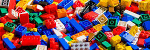 A jumble of LEGO bricks fill the image.