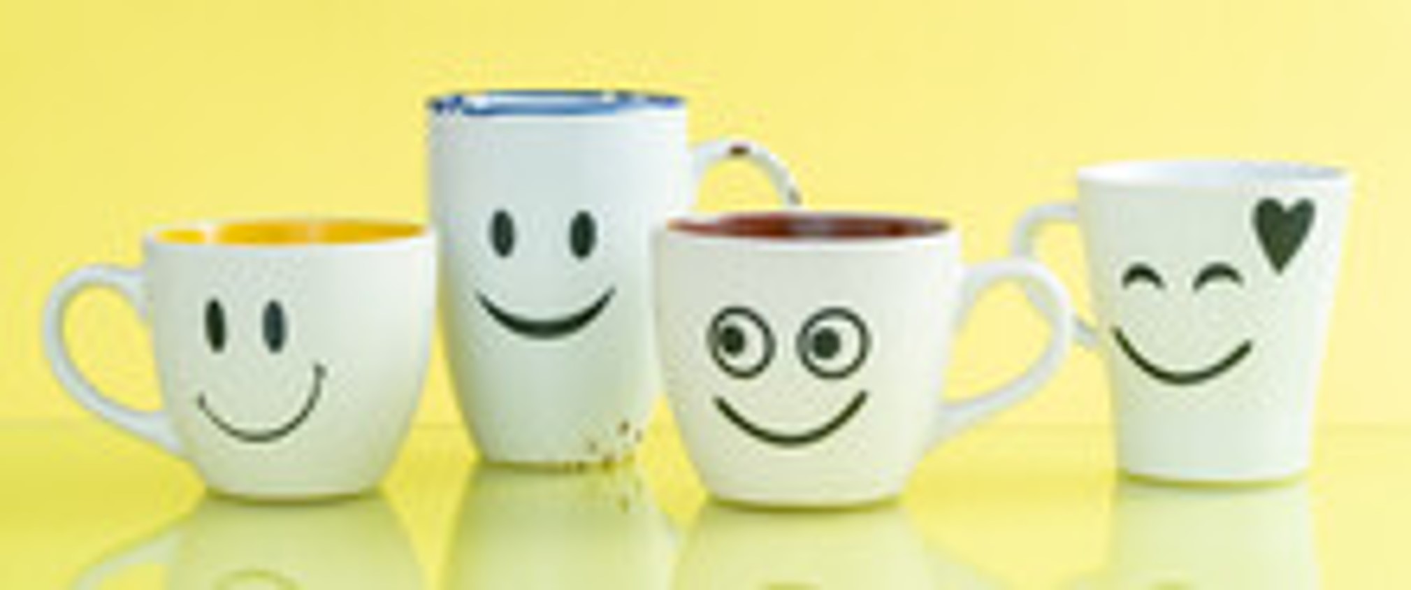 Coffee cups with smiley faces to invite people to come for coffee and meet people