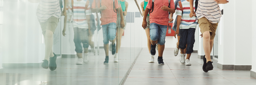 Children running across a school hall
